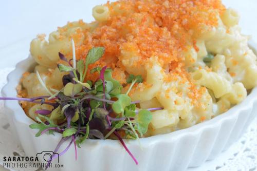 Macaroni and cheese and fancy bowl with stylized baby bean sprouts